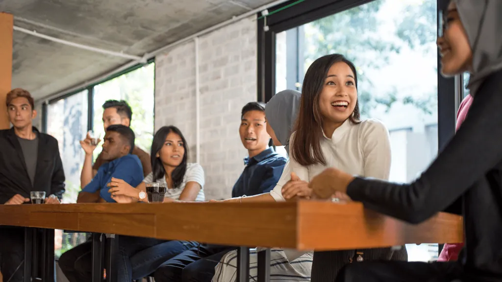 Team smiling during a meeting around a long table
