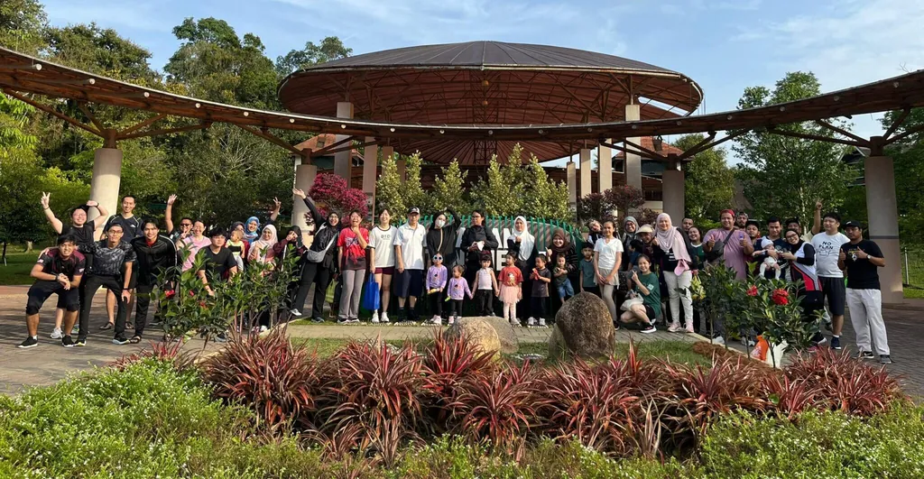 Large group photo outdoors in front of a park pavilion